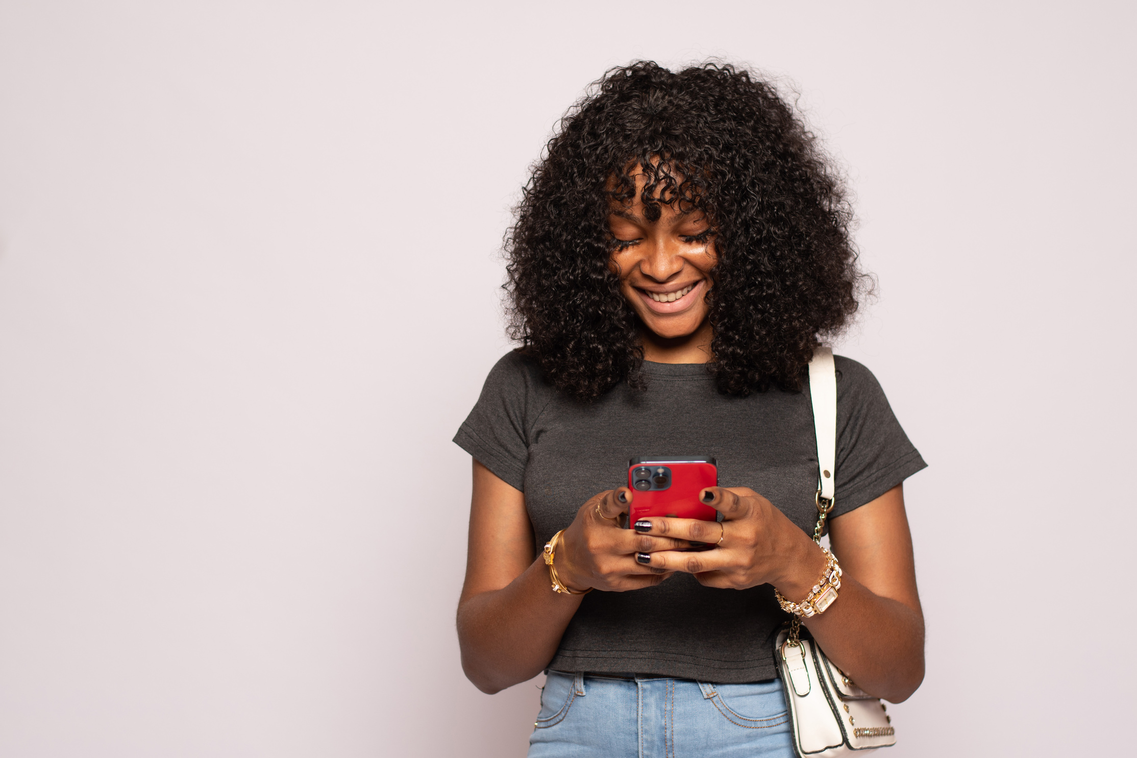 beautiful black girl using her smartphone to text